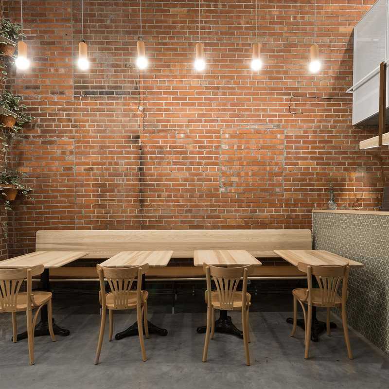 Narrow Lebanese snack bar in Montreal features array of ash furniture