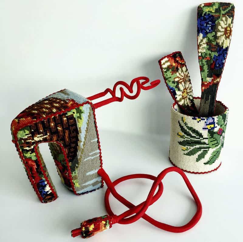 Dressed up vintage household things in cross stich embroiderys return to life as beautiful art objects