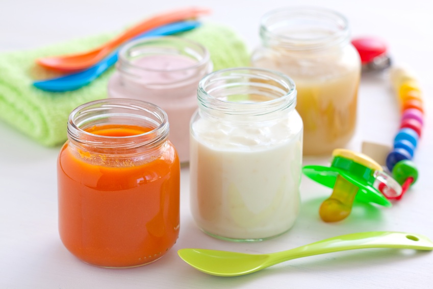 Baby food in jars with a spoon