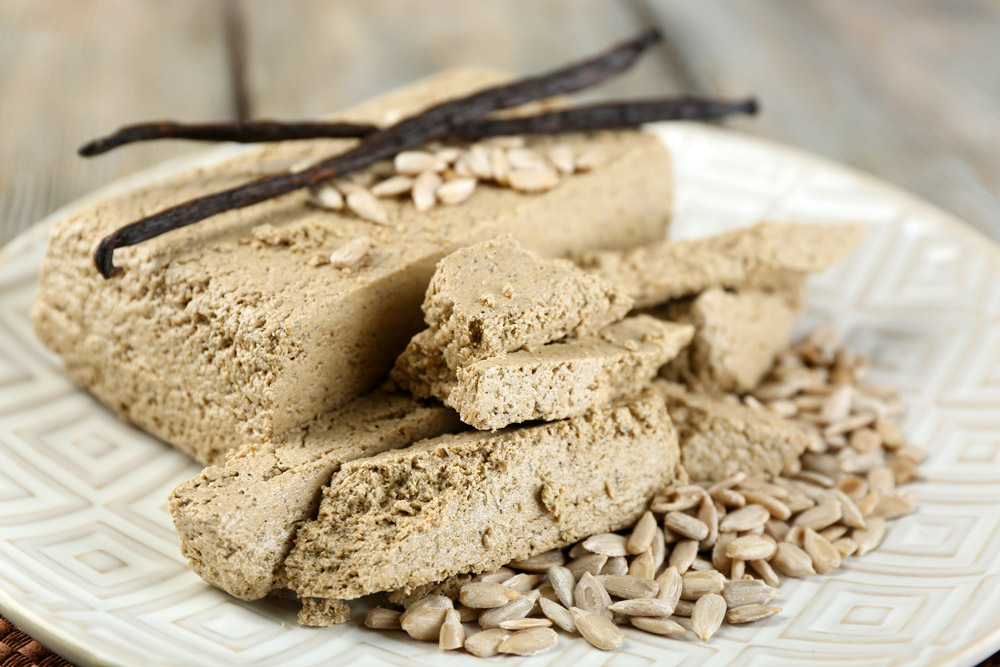 Sunflower halva on a plate with vanilla pods