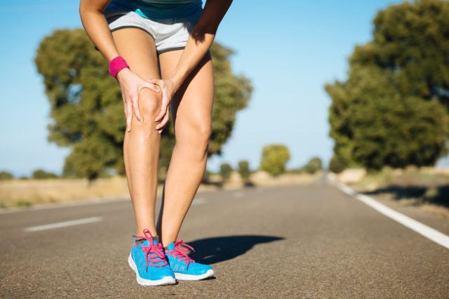 girl holds on to a sore knee